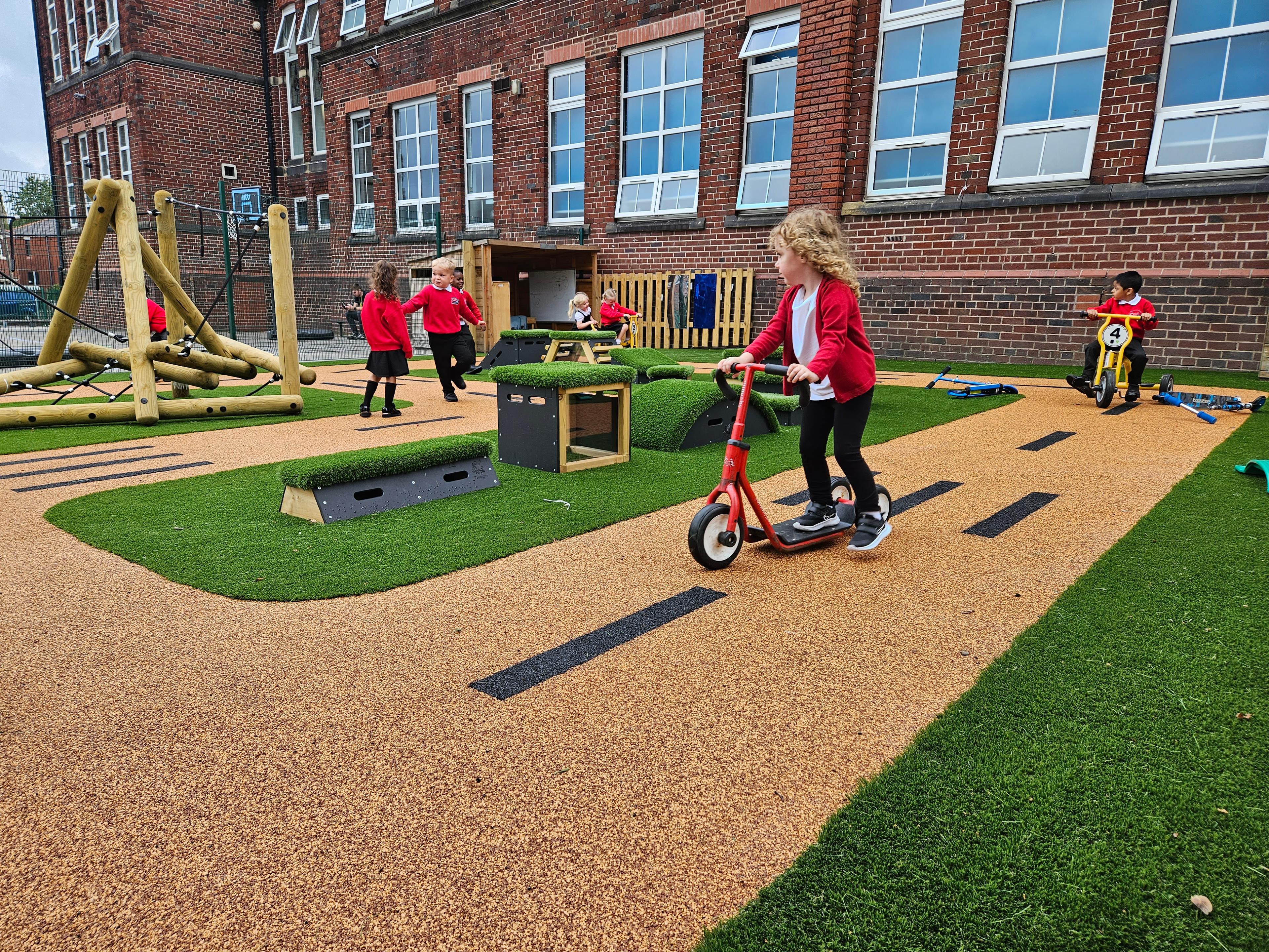 A Pentagon Play bespoke School Playground Scheme with children playing on the playground