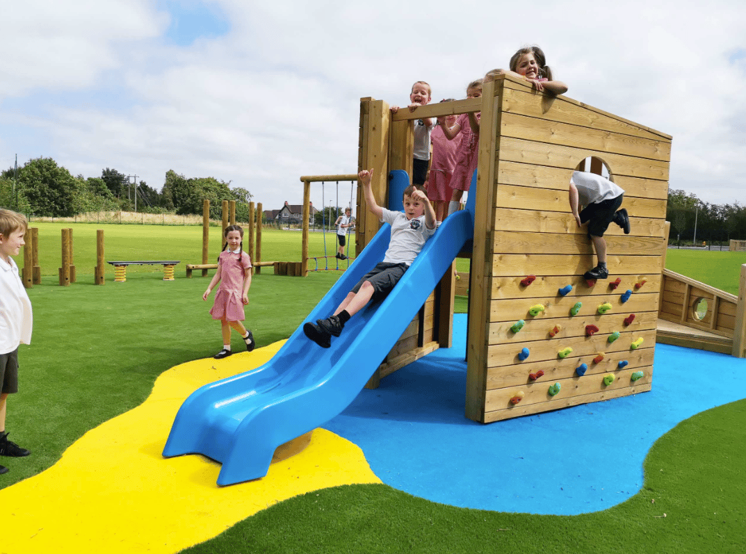 A Pentagon Play bespoke School Playground Scheme with children playing on the playground
