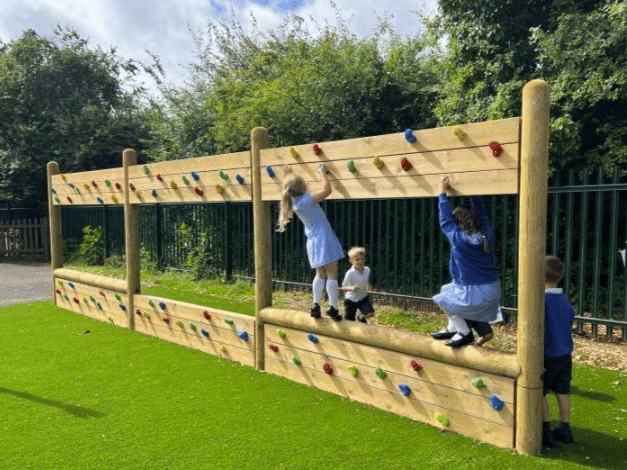 A Pentagon Play bespoke School Playground Scheme with children playing on the playground