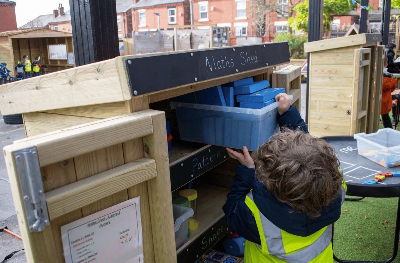 A Pentagon Play bespoke School Playground Scheme with children playing on the playground