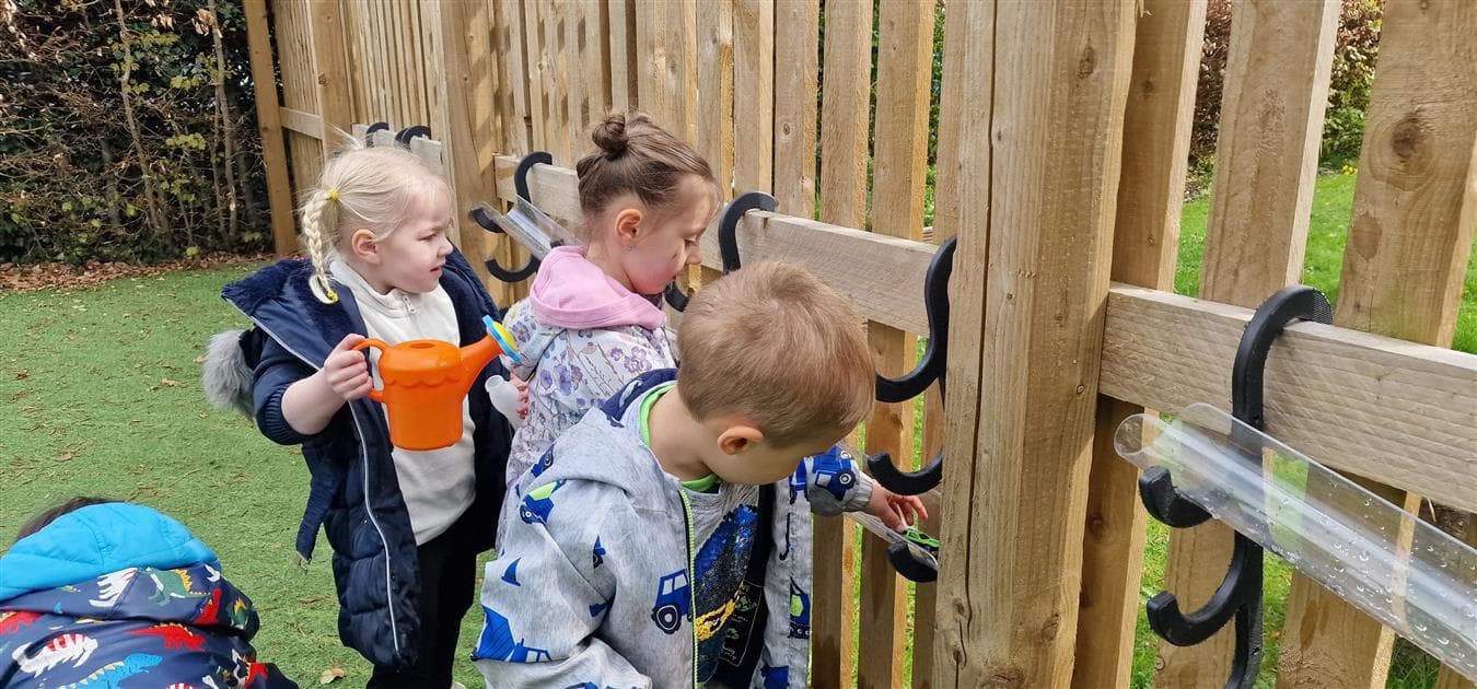 3 children playing on the water channel hooks