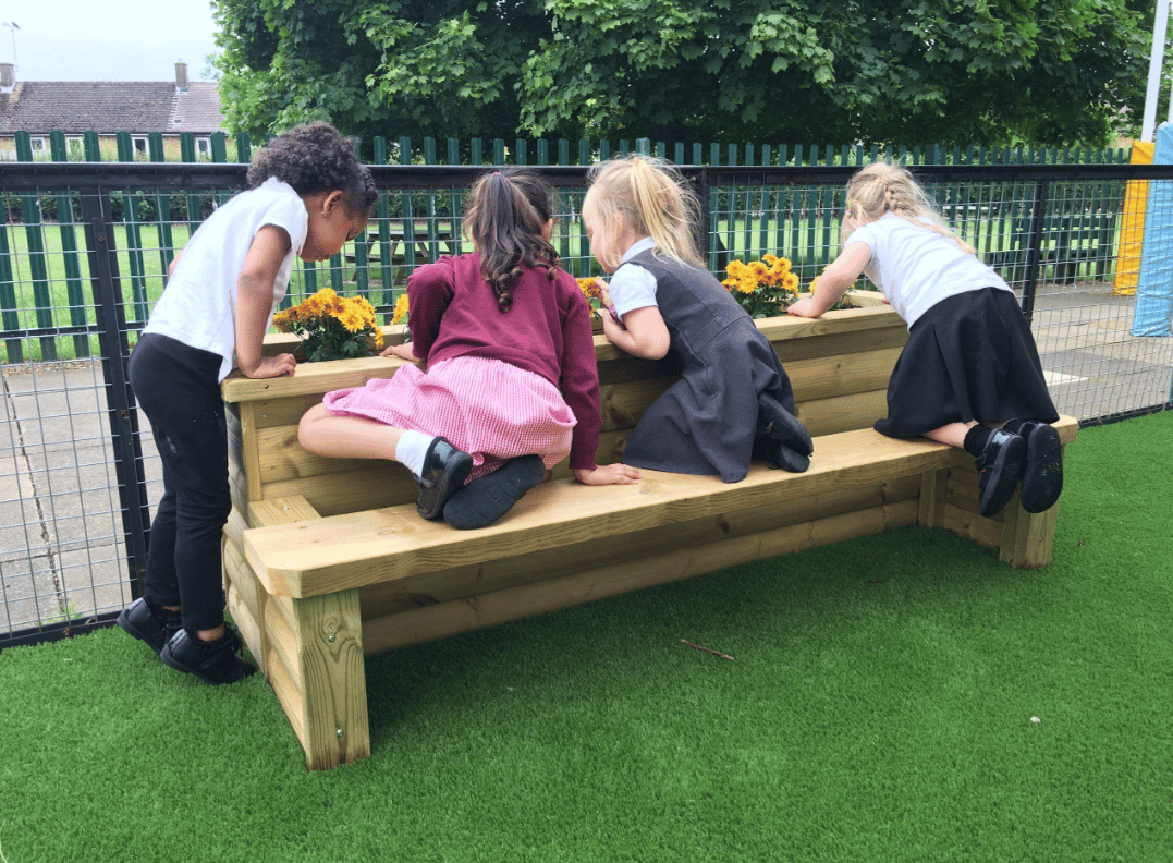 A Pentagon Play bespoke School Playground Scheme with children playing on the playground