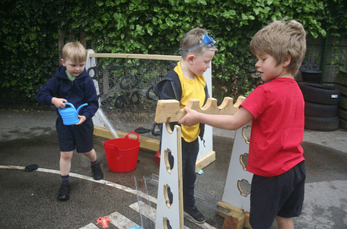 A Pentagon Play bespoke School Playground Scheme with children playing on the playground