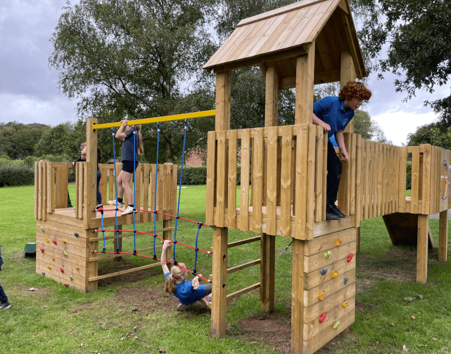 A Pentagon Play bespoke School Playground Scheme with children playing on the playground