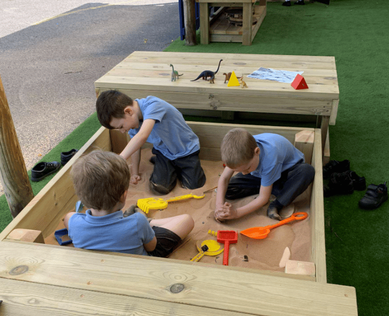 A Pentagon Play bespoke School Playground Scheme with children playing on the playground