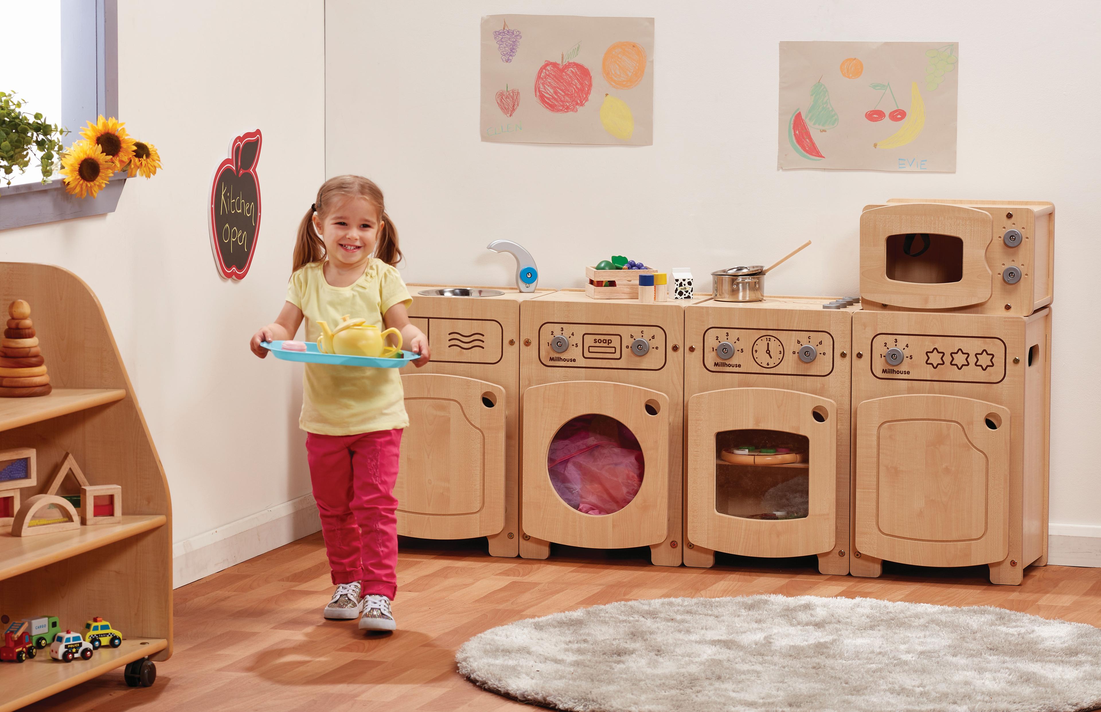 A young girl using the Stamford Kitchen Set including a Microwave, Sink, Fridge, Washer & Cooker