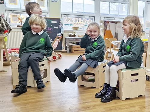 School children sat on Stack and Sit Stools.