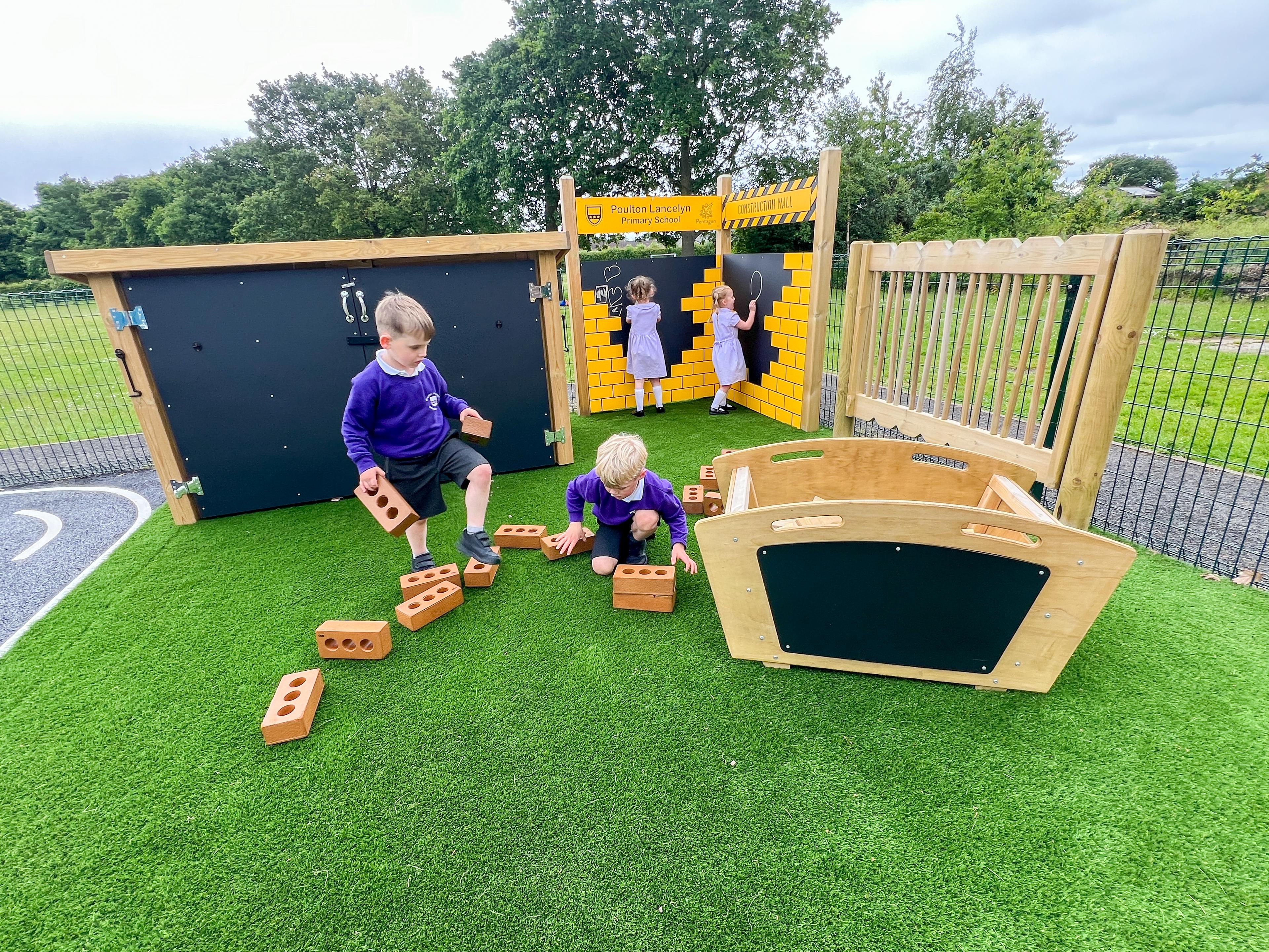Children playing with the Maxi Construction Skip in an EYFS Construction Zone