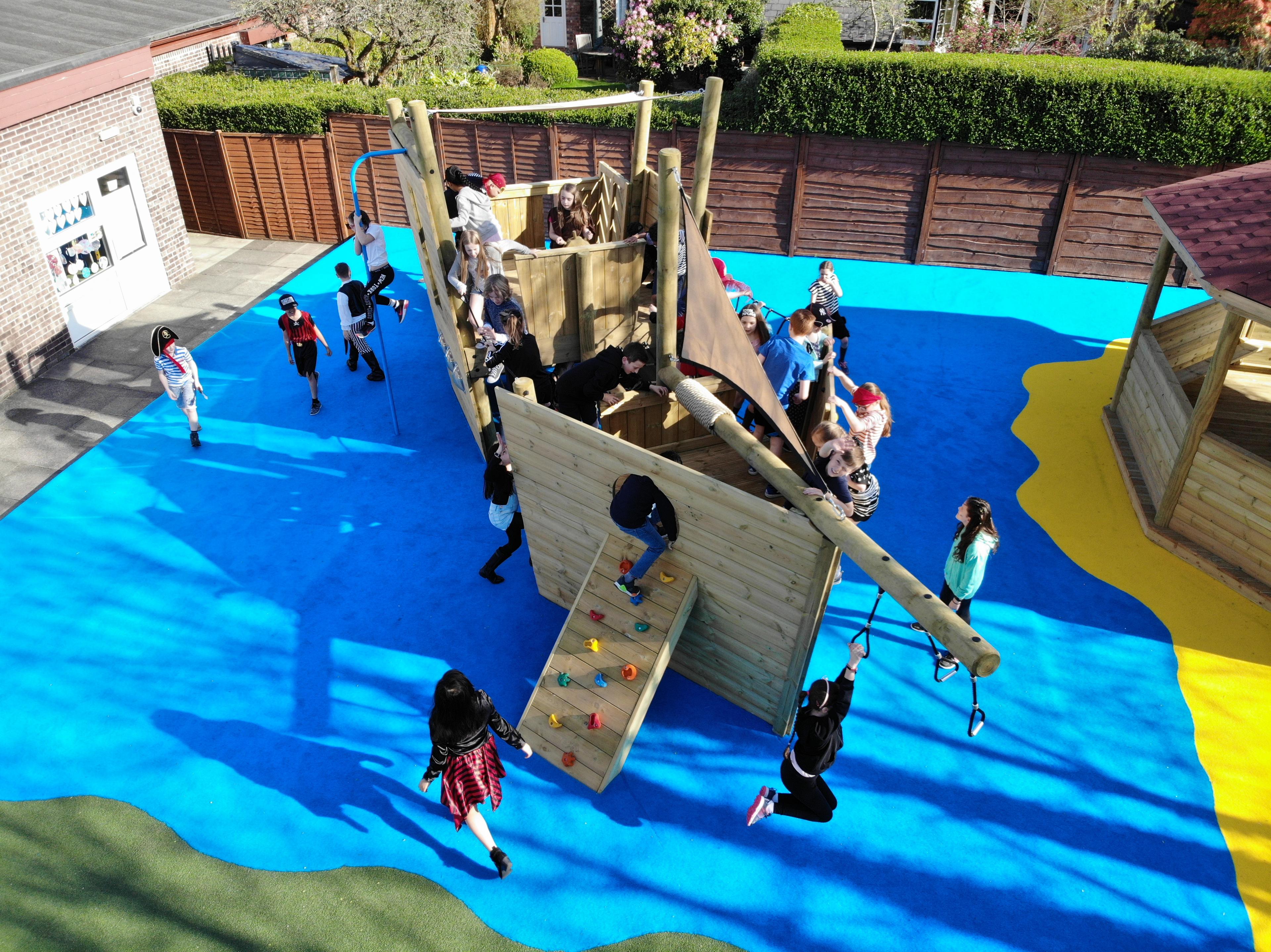 A drone photo of the North Sea Galleon surrounded by bright blue wetpour with lots of children playing on the ship.