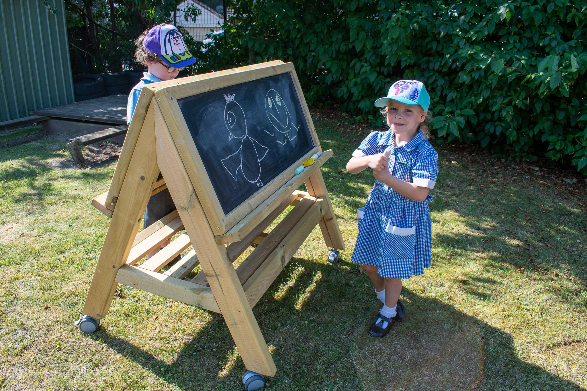 Children drawing on Easel on Wheels