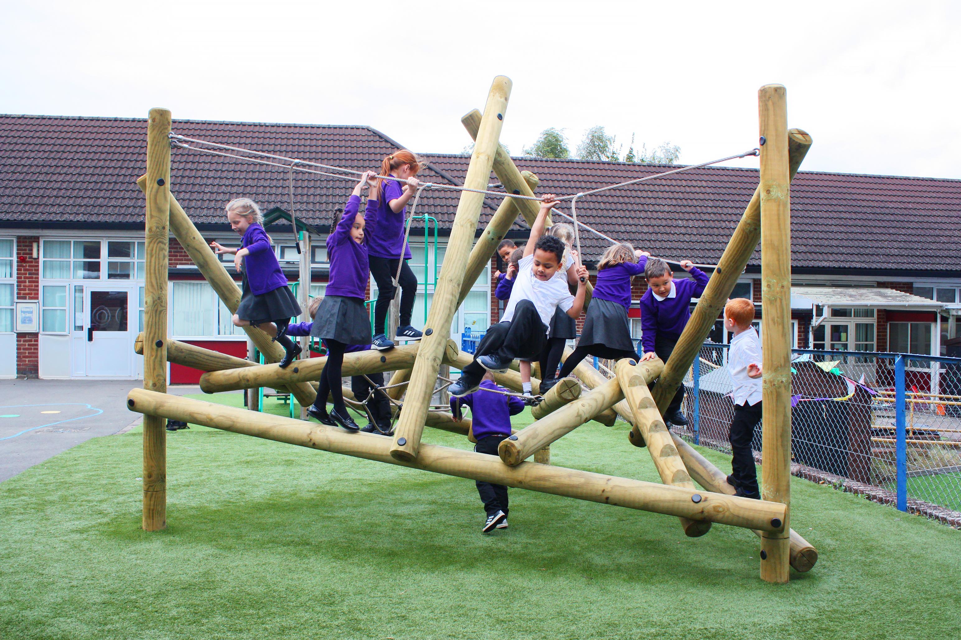 A medium-sized play frame climber with 12 children climbing on it.